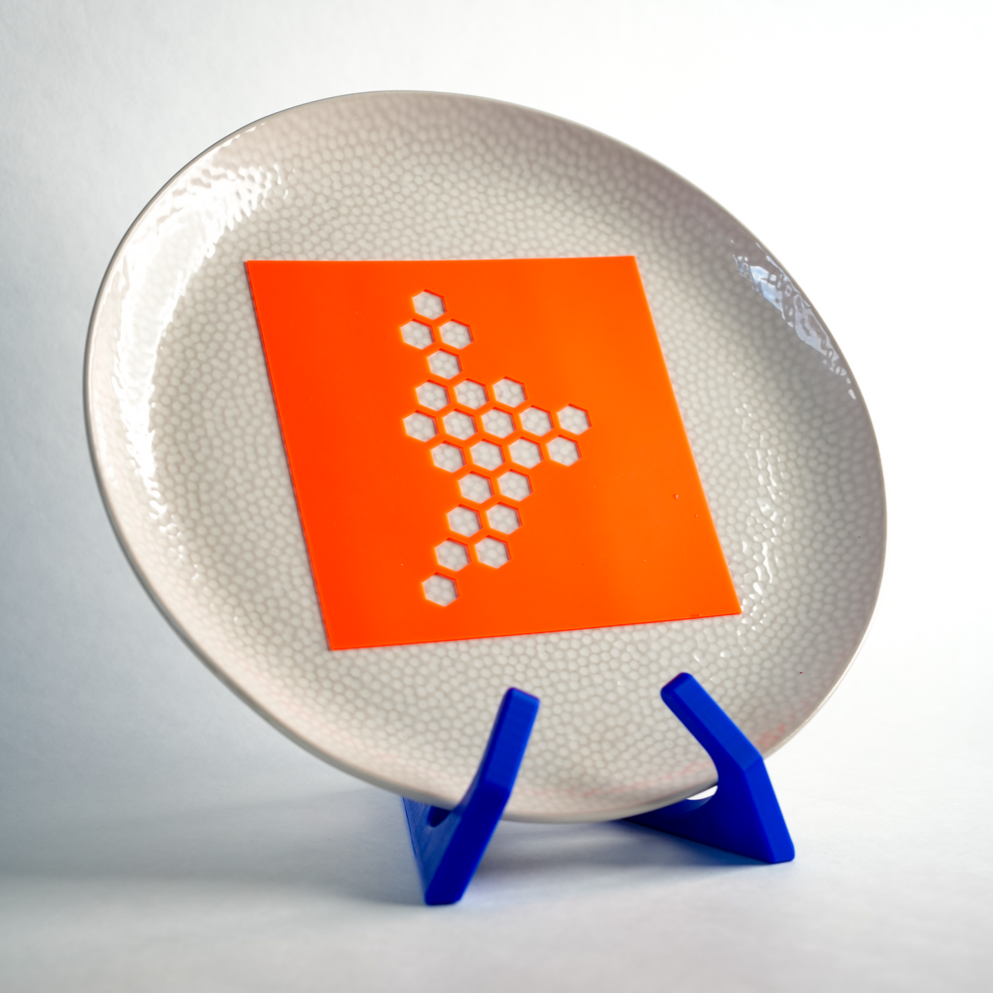 Silicone Buzz Hive stencil placed on a plate, ready to create a honeycomb pattern