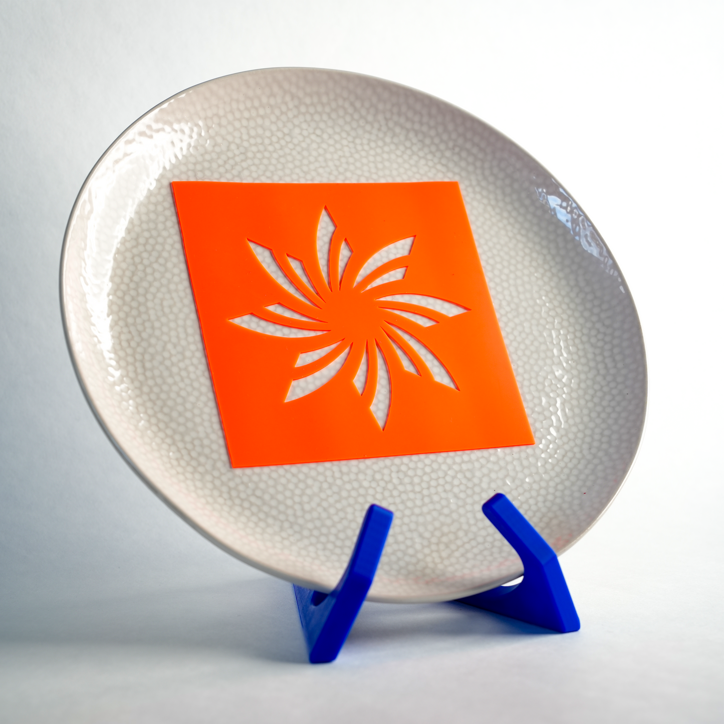 Silicone Cosmic Swirl stencil placed on a plate, ready to create a swirling, celestial pattern