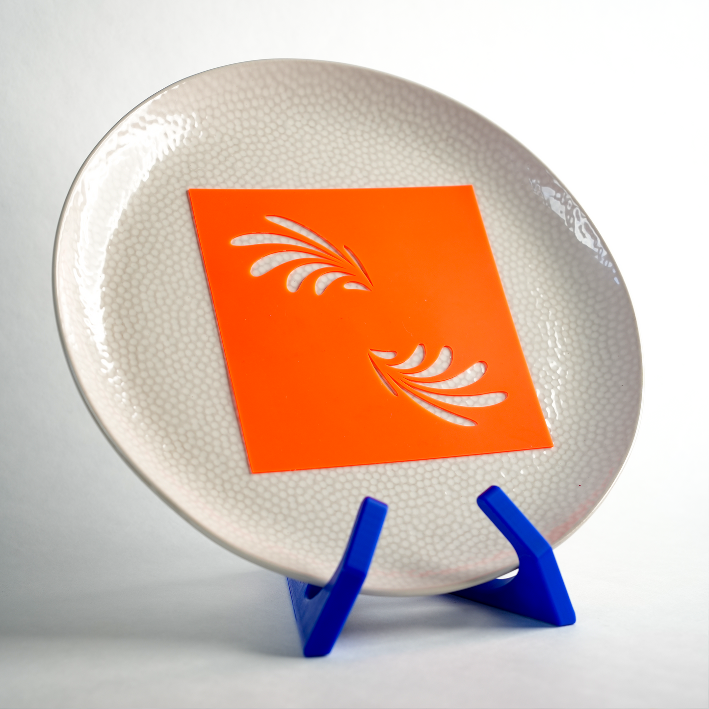 Silicone Leaf Wings stencil placed on a plate, ready to create an elegant wing-like design.