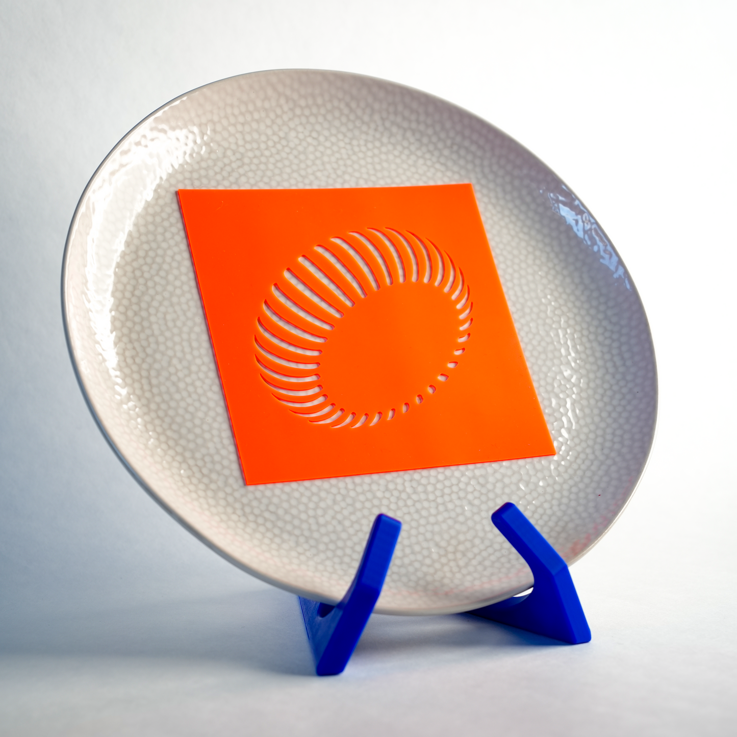 Silicone Radial Wheel stencil placed on a plate, ready to create a symmetrical, circular pattern