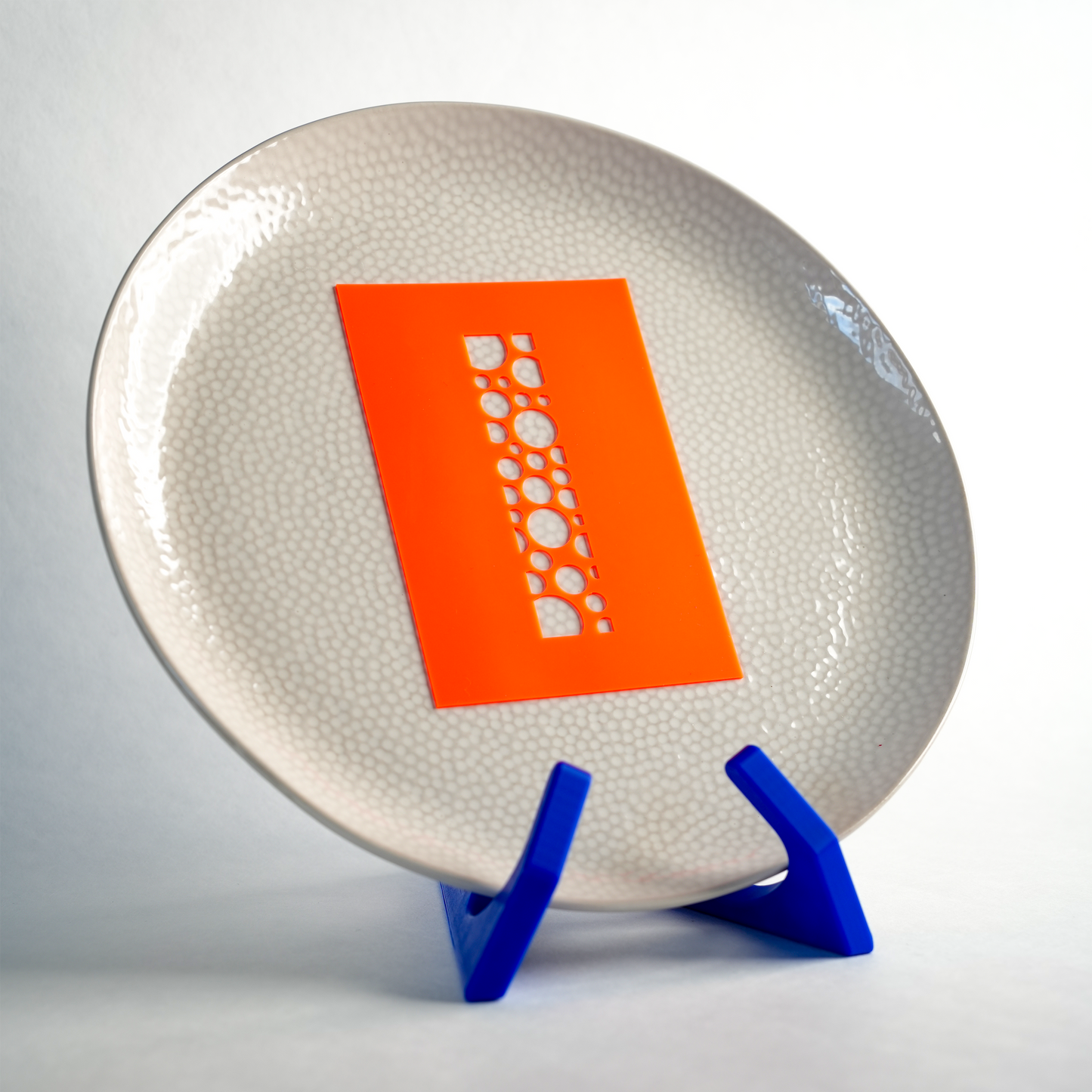 Silicone RectaDots stencil placed on a plate, ready to create a clean dot pattern design.