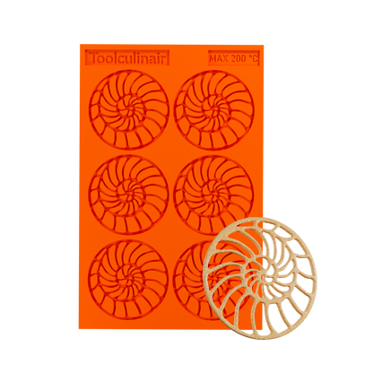 Photo of the Ammonite food safe silicone tuile mold alongside a matching tuile cookie, showcasing intricate spiral shell design ideal for sweet and savory pastry decorations.