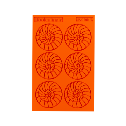 Top view photo of the Ammonite food safe silicone tuile mold, featuring detailed spiral shell cavities perfect for crafting elegant sweet and savory pastry decorations.