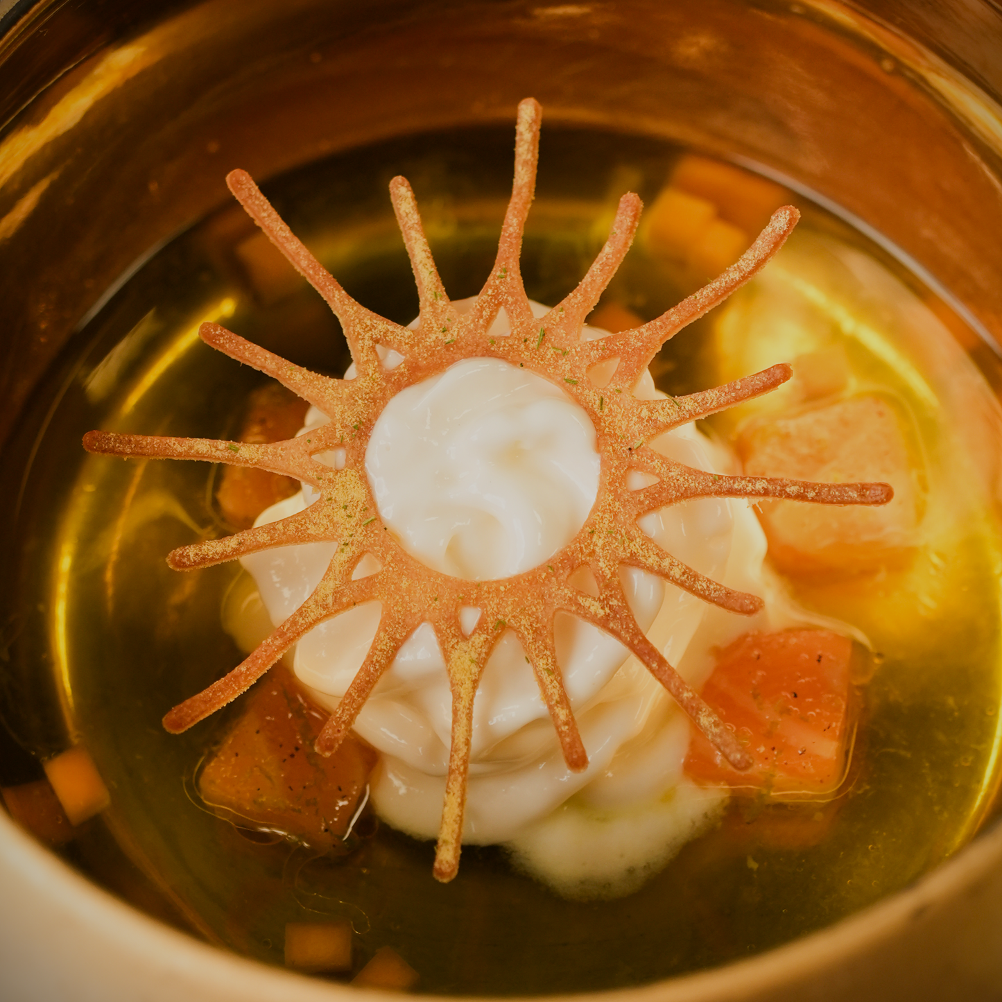 Amuse dish at restaurant De Moerbei featuring a solar-shaped silicone tuile cookie for decorative presentation