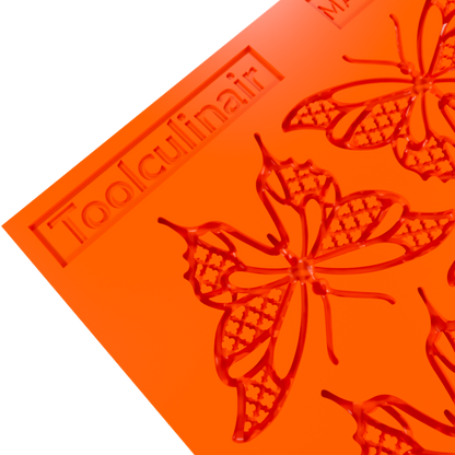 Close-up 3D render of an orange Toolculinair silicone butterfly tuile mold, showing detailed wing patterns of the mold cavity with visible Toolculinair logo on the surface.