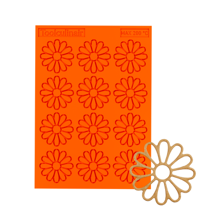 3D render of an orange Toolculinair chamomile line art silicone tuile mold with logo and 200°C marking, showing the chamomile flower shape detail in the bottom right corner.