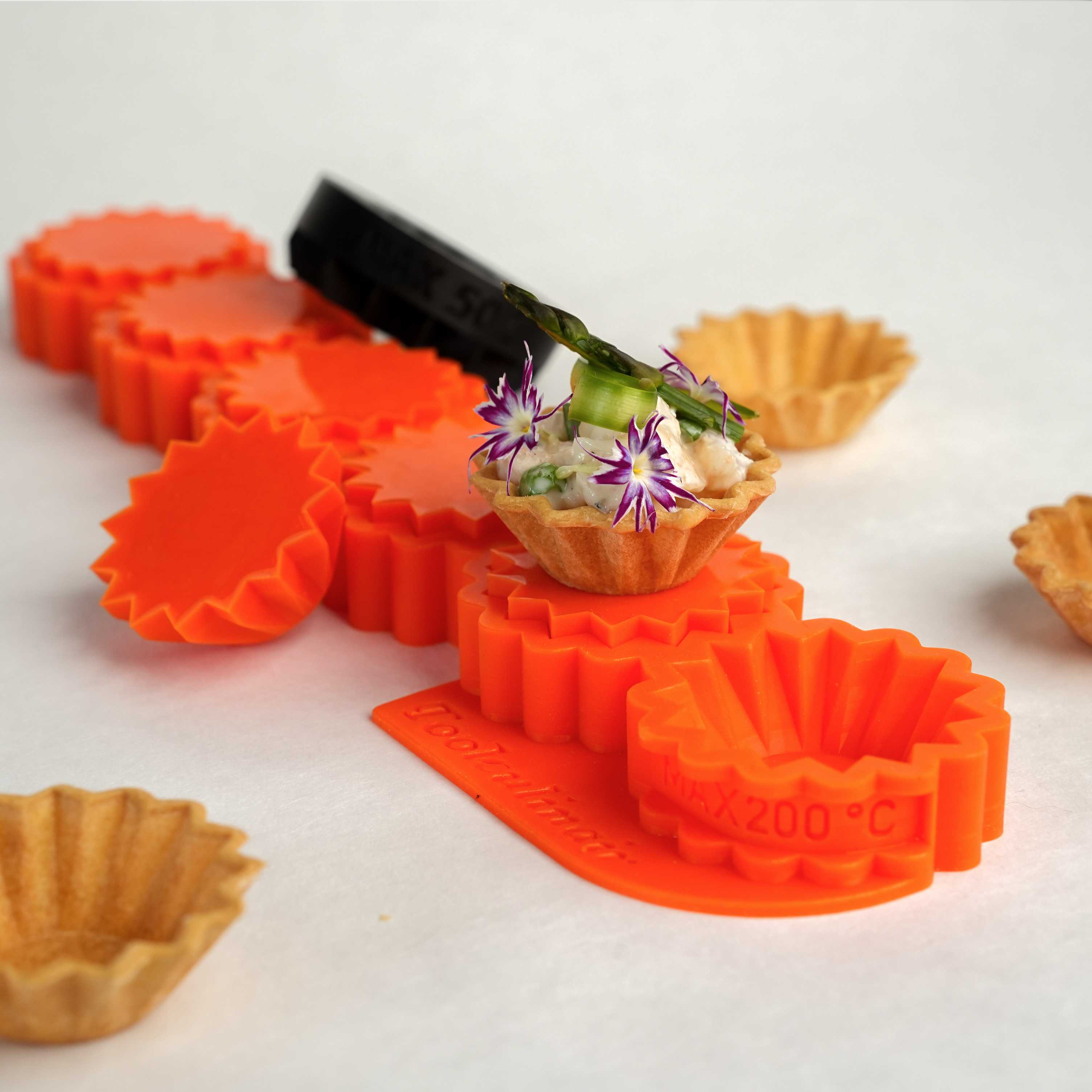 Complete view photo of the crimped food safe silicone tartelette mold, designed for creating decorative pastry shells with detailed edges, ideal for sweet and savory dishes.