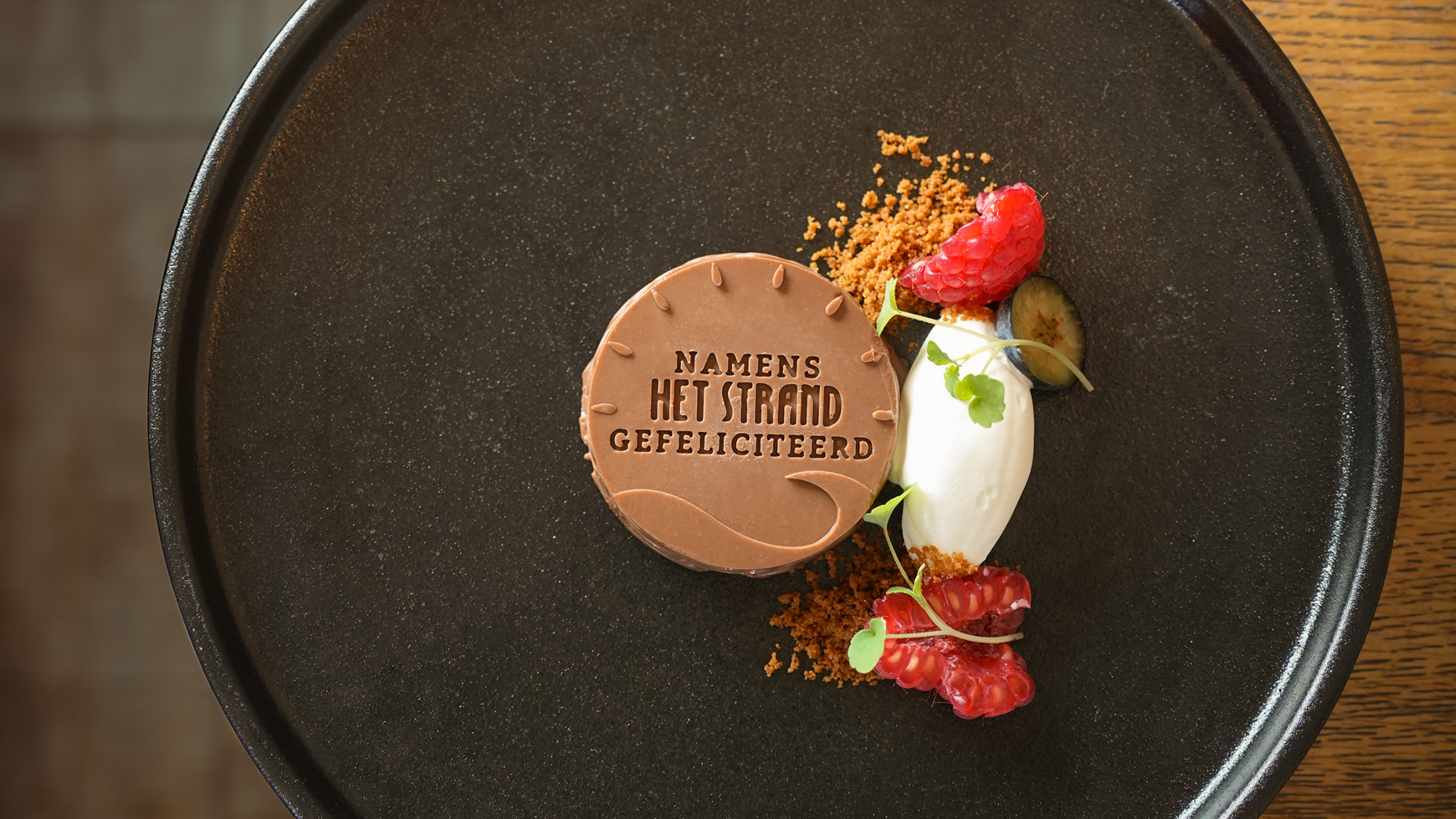 Custom silicone mold dessert at restaurant Het Strand featuring chocolate mousse made using our silicone mold, served with fresh fruit and a quenelle of whipped cream for an elegant presentation.