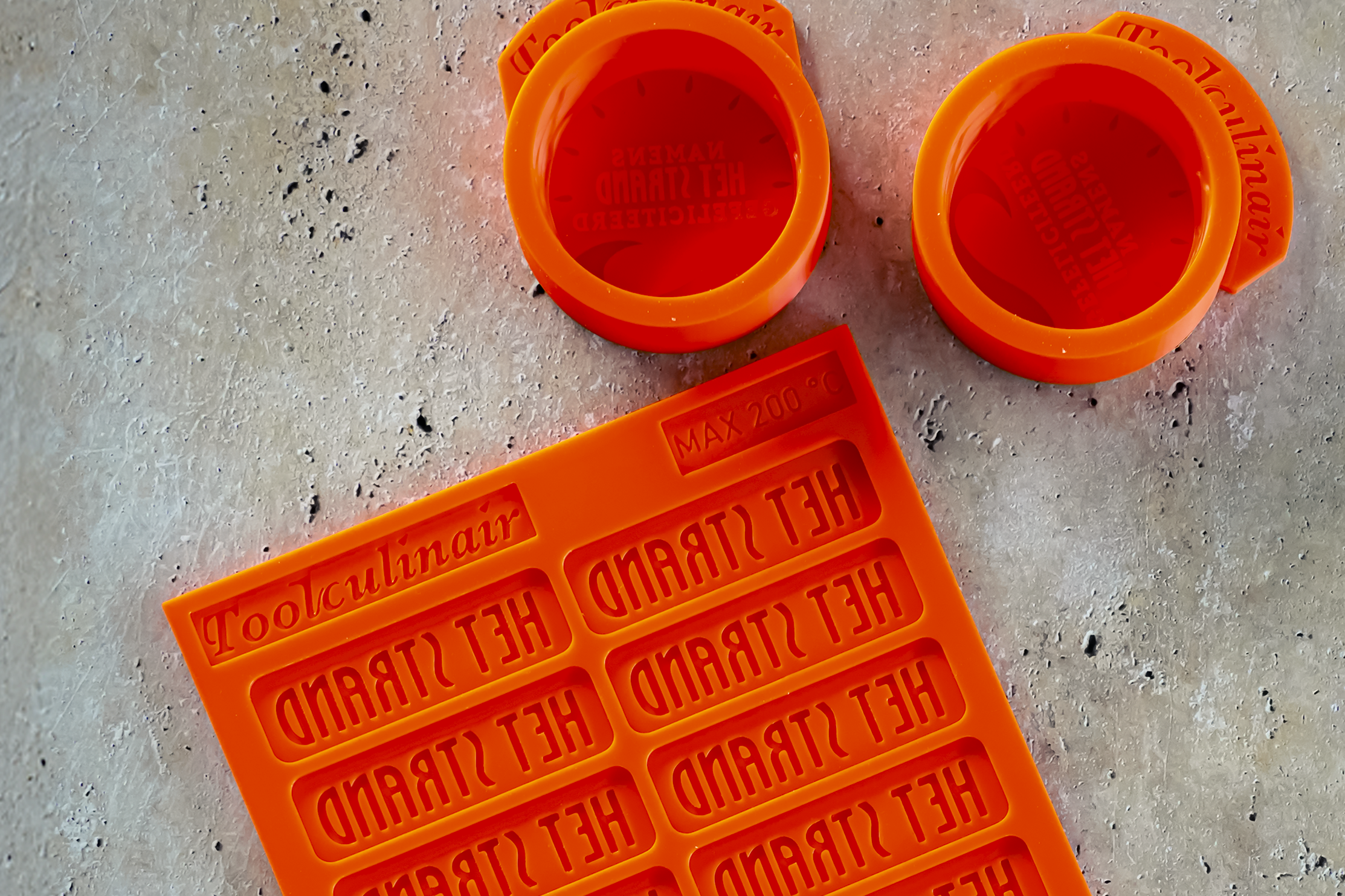 Custom silicone molds made for restaurant Het Strand, featuring one tuile mold and three 3D molds with the restaurant’s logo – designed for creative plating and professional kitchen use.