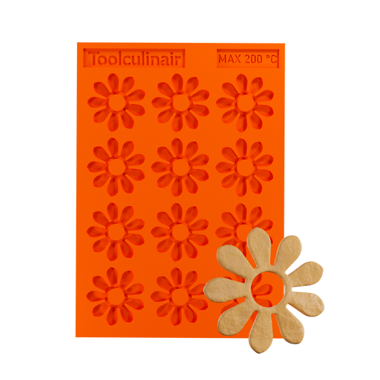 Photo of the Enneaflower food safe silicone tuile mold with a matching tuile cookie, showcasing elegant nine-petal floral design ideal for sweet and savory pastry decorations.