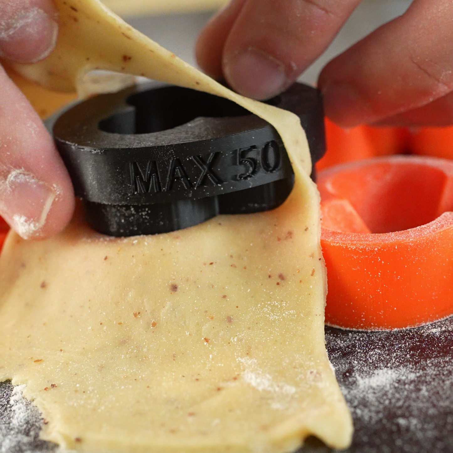 Close up photo of the Flora silicone tartelette cutter showing temperature of 50 degrees Celsius, highlighting durable and heat resistant design for precise pastry cutting.