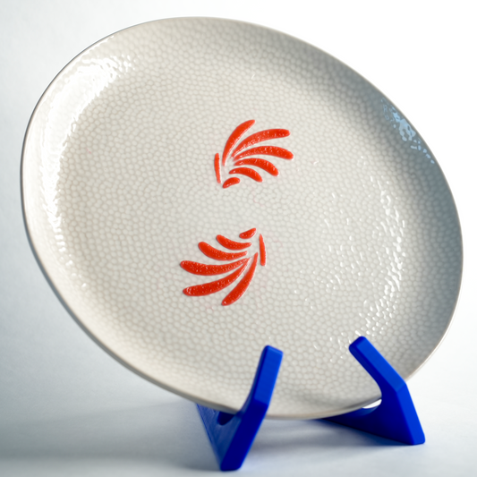 Finished plate with a delicate wing-like pattern created using the Leaf Wings silicone stencil.