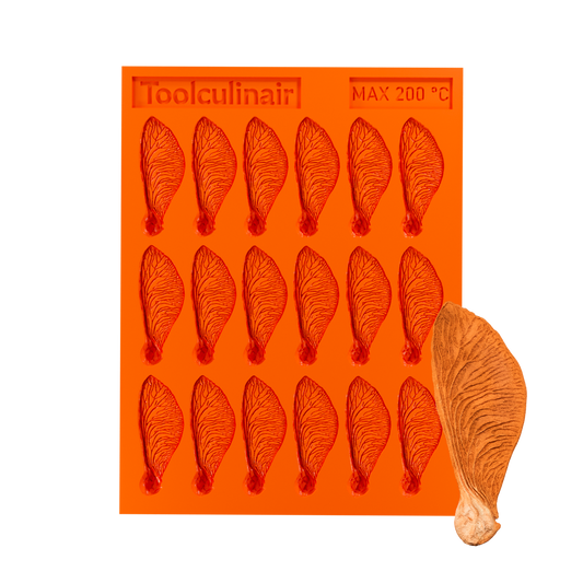 Samara silicone tuile mold alongside a perfectly baked winged tuile cookie, inspired by the helicopter seed, ideal for elegant dessert presentation.