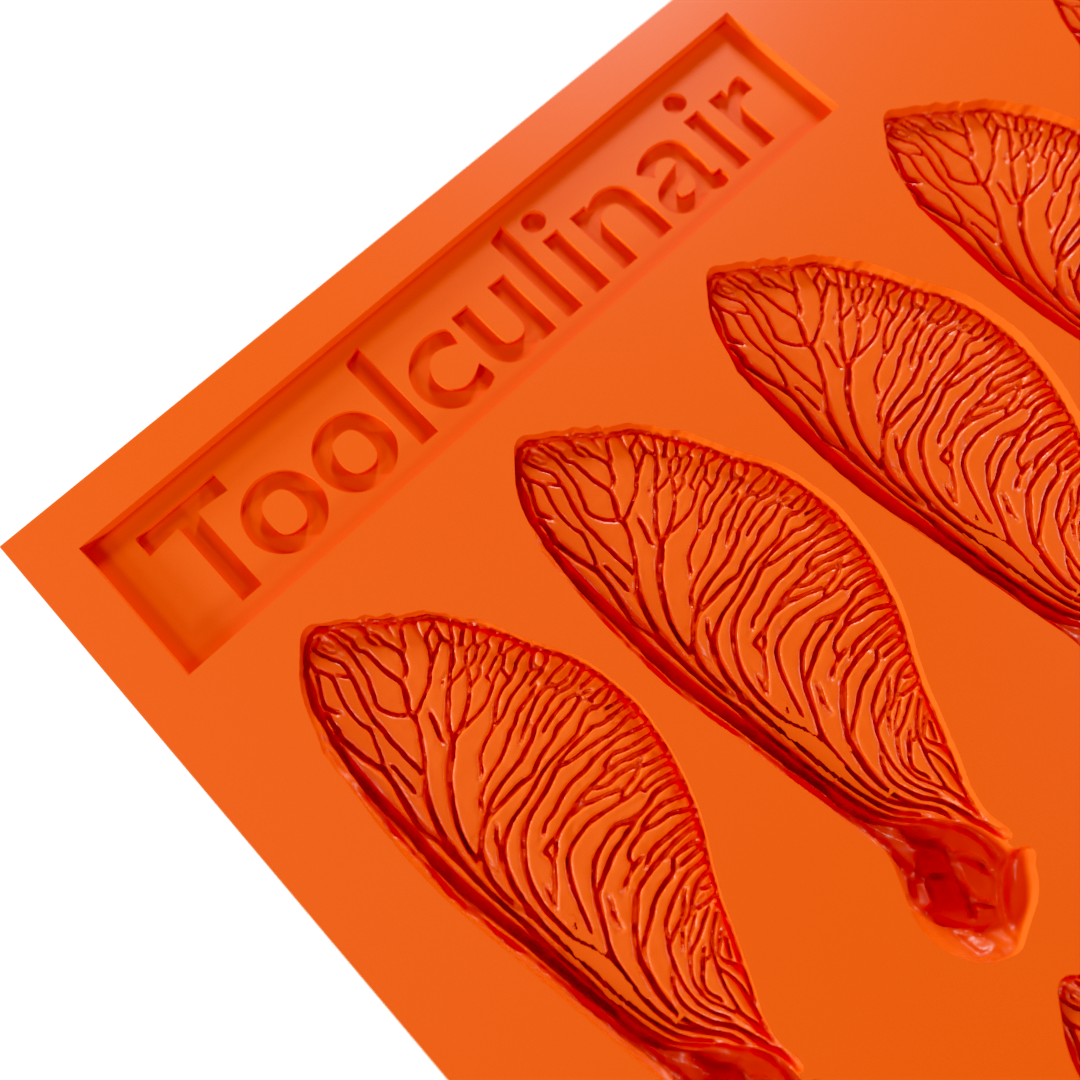 Close-up of the Samara silicone tuile mold, showing the detailed grooves for creating delicate, helicopter seed–inspired tuiles.