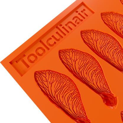 Close-up of the Samara silicone tuile mold, showing the detailed grooves for creating delicate, helicopter seed–inspired tuiles.