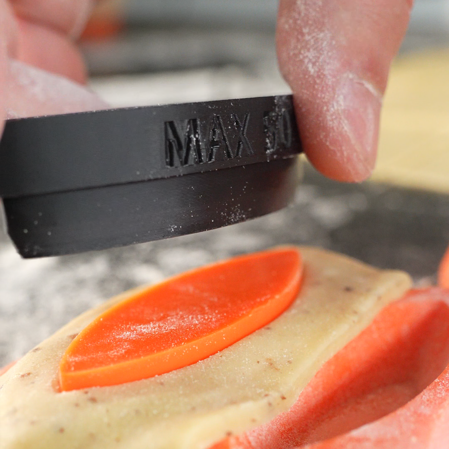 Close up photo of the Sculptura cutter designed for tartelette molds, featuring sharp edges and ergonomic handle for precise and easy pastry cutting.