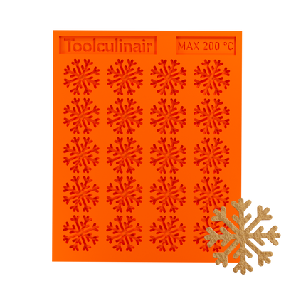 Snowflake silicone tuile mold with a tuile cookie, ideal for baking decorative and detailed pastries