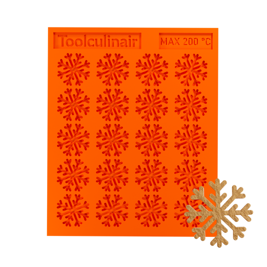 Snowflake silicone tuile mold with a tuile cookie, ideal for baking decorative and detailed pastries
