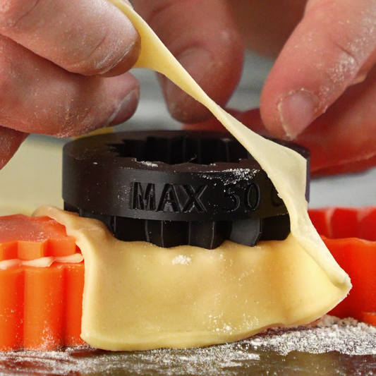 Close-up action photo of a tartelette cutter in use sharp and ergonomic kitchen tool designed for precise pastry shell cutting in professional baking.