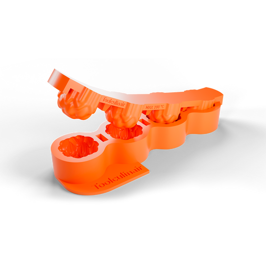 3D render of an orange Toolculinair artichoke dome silicone mold showing the unmolding process, with the top part being lifted upward to reveal how the shape is released, including visible Toolculinair logo.