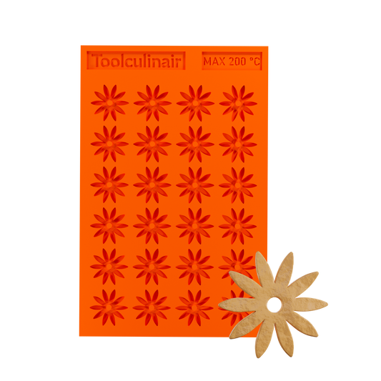 Photo of the Stellaria food safe silicone tuile mold alongside a matching tuile cookie, showcasing delicate star-shaped pastry decoration perfect for sweet and savory dishes.